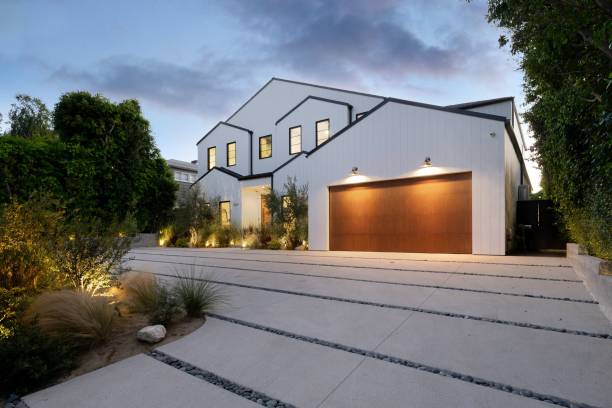Exterior of a modern-style home with wooden garage door and large windows