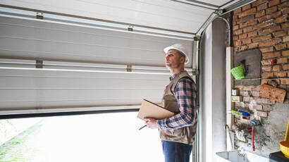 Technician inspecting residential garage door