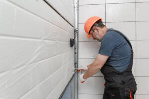 Technician installing lifting gates of a new garage door