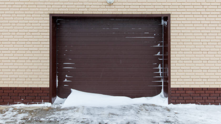 Composite garage door covered in snow