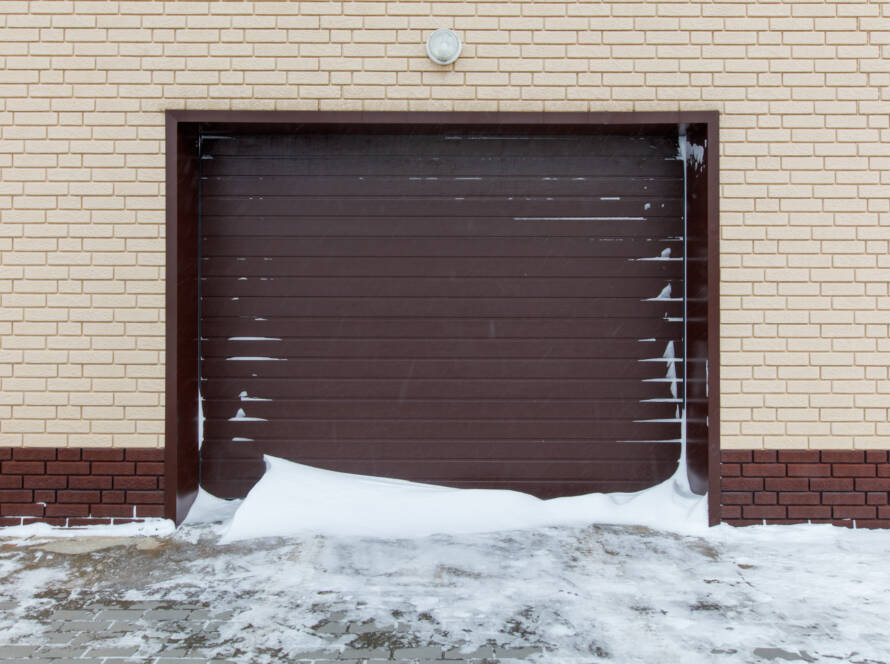 Composite garage door covered in snow