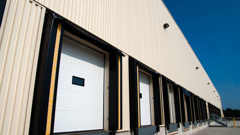 Row of warehouse loading docks with sectional doors