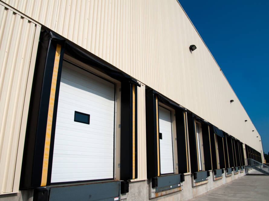 Row of warehouse loading docks with sectional doors