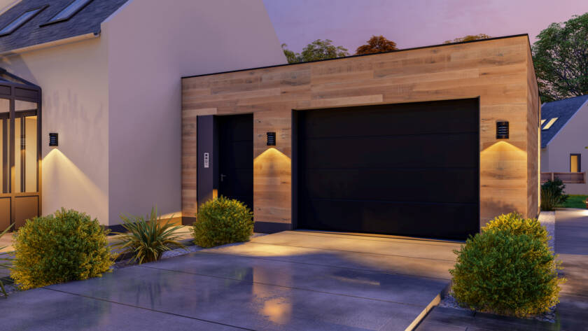 Sleek modern garage door without windows illuminated at sunset