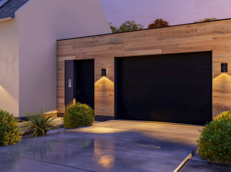 Sleek modern garage door without windows illuminated at sunset