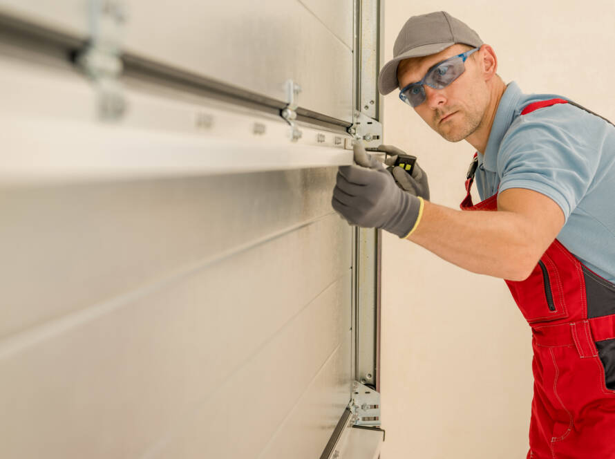 Technician installing brand new residential garage door