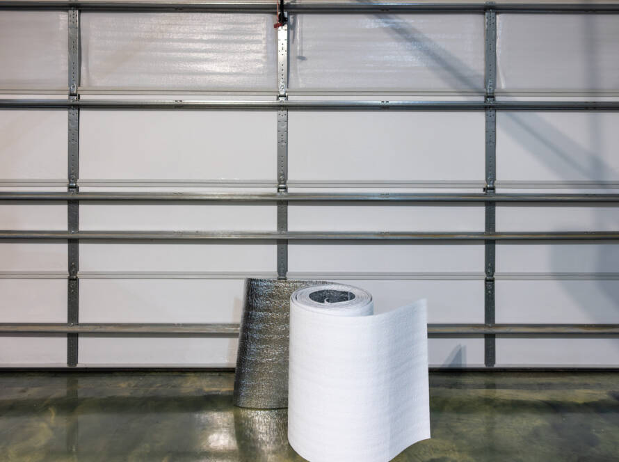 White garage door with roll of insulation