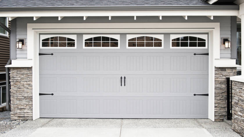 Gray garage door with windows and hardware