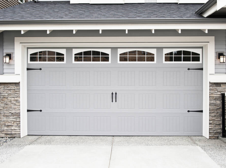 Gray garage door with windows and hardware