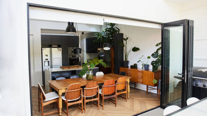 Open patio door connecting dining room to outdoor living space