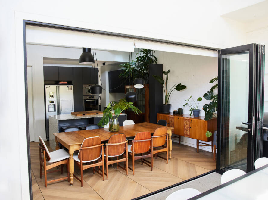 Open patio door connecting dining room to outdoor living space